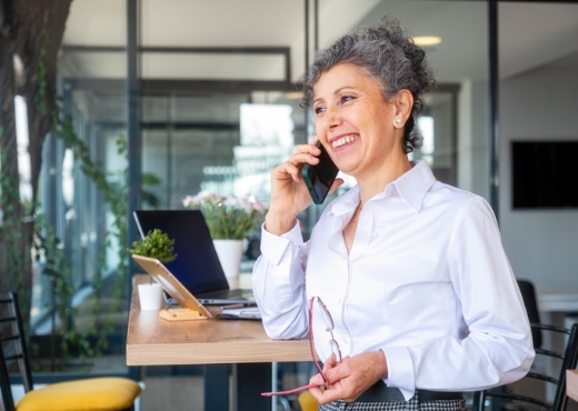 Woman smiling while talking on cell phone