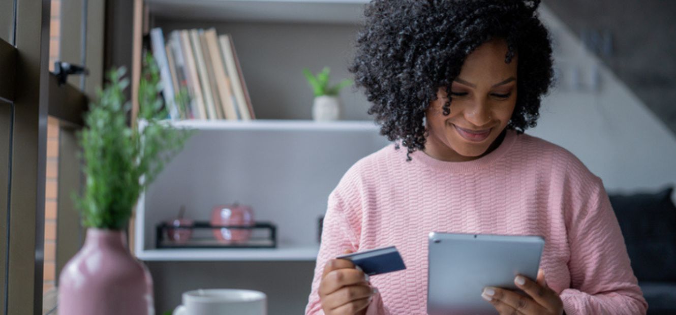 Woman holding tablet and credit card