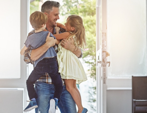 Father hugging children