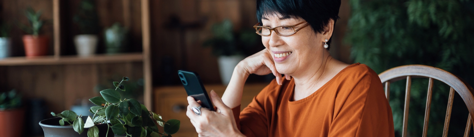 Woman smiling and looking at cell phone