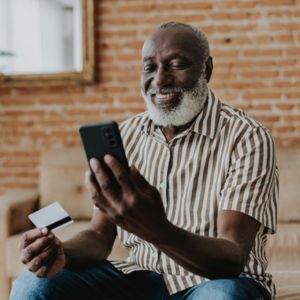 Man holding smartphone and credit card